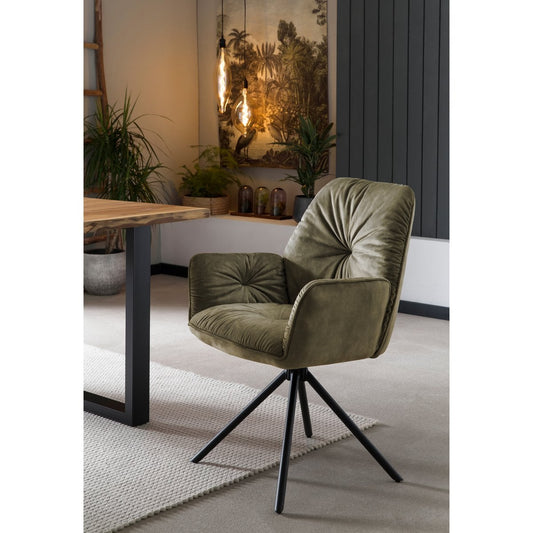 Groene velours eetkamerstoel van SalesFever met 360 graden draaifunctie en zwarte metalen poten, in een moderne setting.